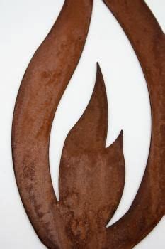 An Old Rusty Metal Fire Symbol On A White Wall