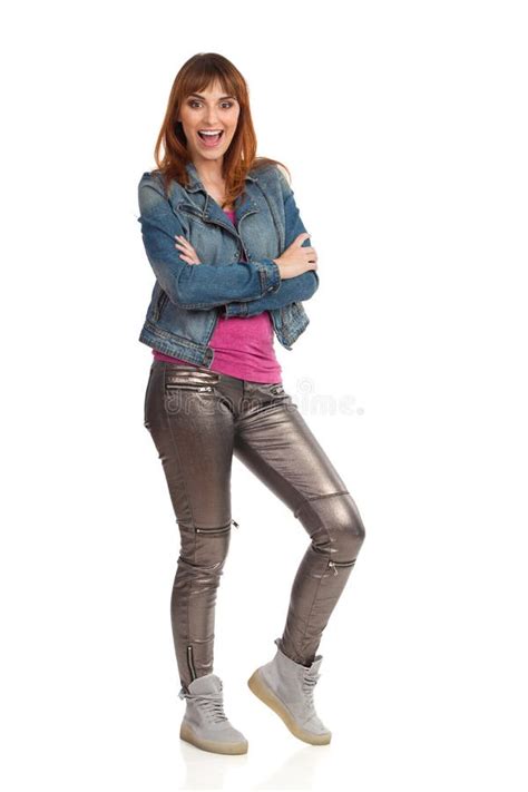 Laughing Young Woman In Jeans Jacket And Shiny Pants Is Standing With