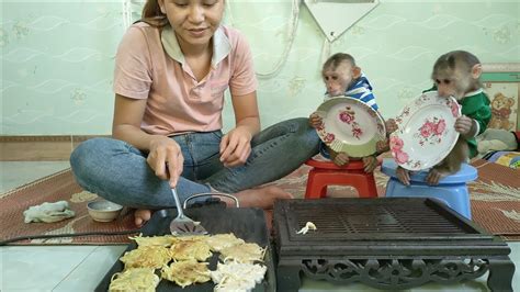 Mimi Kuku Holds A Plate And Waits For Her Mother To Fry Potato Cakes