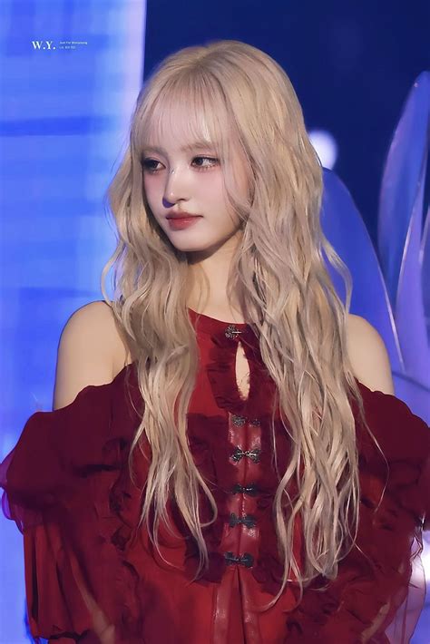 A Woman With Long Blonde Hair Wearing A Red Dress