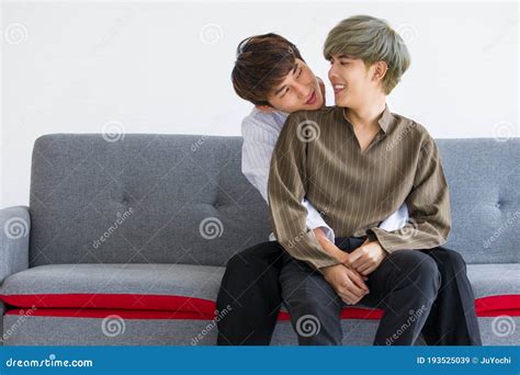 Gay Couples Are Embracing And Making Eye Contact Together On The Sofa Stock Image Image Of