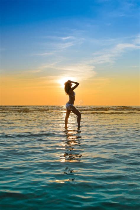 Woman In White Bikini Posing In A Sea At Sunset Stock Photo Image Of