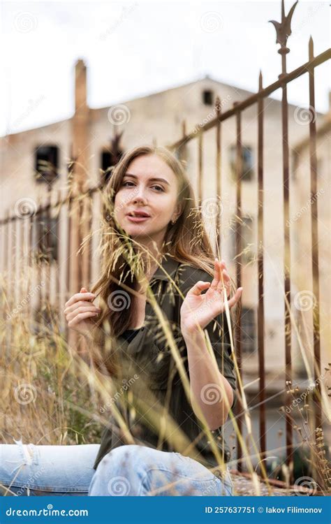 Woman Posing Near Fence Against Abandoned Building Stock Image Image Of Outside Aesthetic