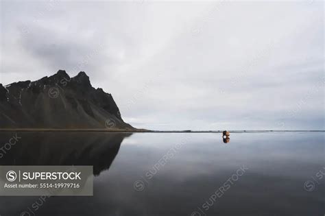 Naked Woman On The Beach With Great Reflection And Mountains Superstock