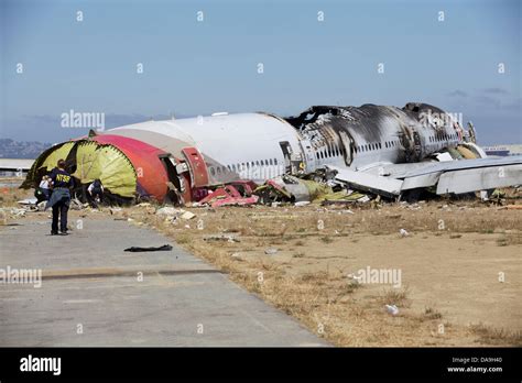 Ntsb Investigators View The Remains Of The Asiana Flight 214 Boeing 777 Near The Runway Where It