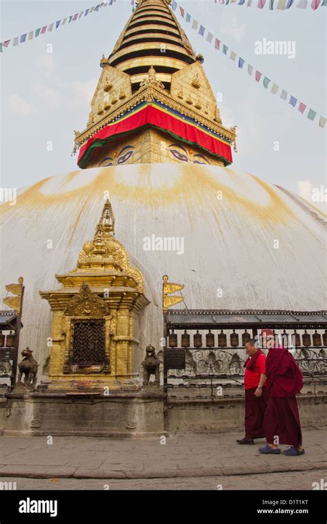 Monks Walk Past Prayer Wheels Around The Stupa At Boudhanath Temple