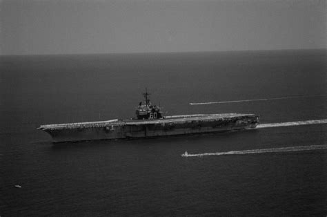 Crew members man the rail as the aircraft carrier USS SARATOGA (CV 60 ...