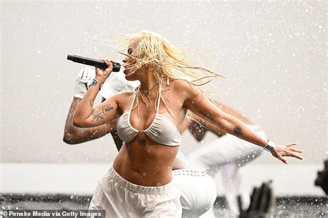 Karol G Shows Off Her Impeccable Figure In A White Bikini Top During A Steamy Performance As She