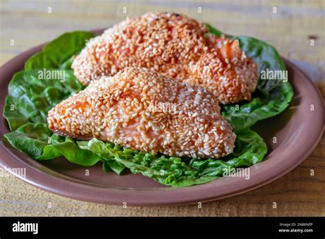 Portion Of Sesame Crusted Salmon On Lettuce Stock Photo Alamy