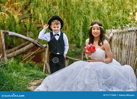 Stylish Boy Is Photographed Together With An Elegant Bride Stock Photo