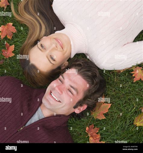 Couple laying in grass Stock Photo - Alamy