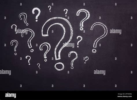 Lots Of Question Marks Drawn In Chalk On A Black Chalkboard Stock Photo