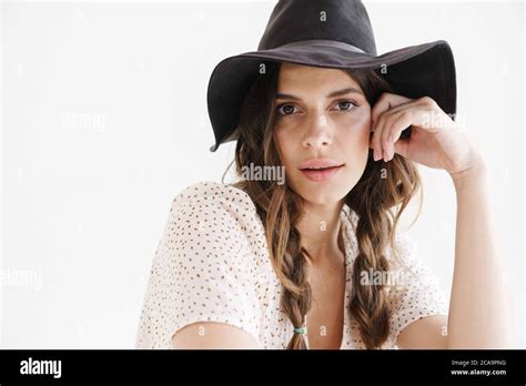 Photo Of Brunette Seductive Woman In Hat Posing And Looking At Camera Isolated Over White