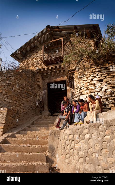 India, Arunachal Pradesh, Dirang Dzong, young people sat on steps at ...