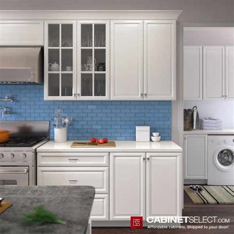 A Kitchen With White Cabinets And Blue Backsplash