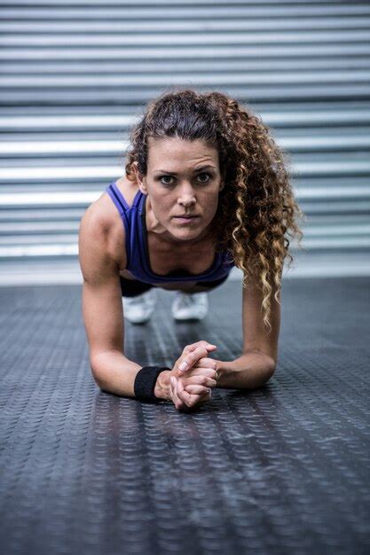 Premium Photo Portrait Of Muscular Woman Doing Push Ups