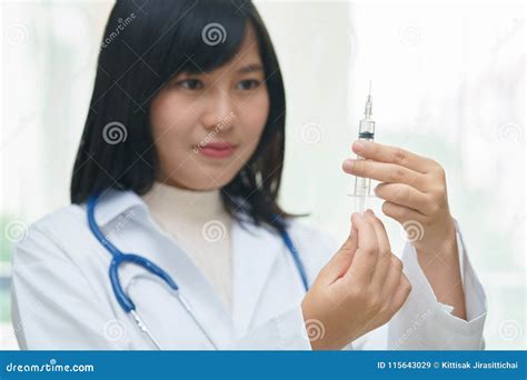 Female Doctor Or Physician Holding Hypodermic Syringe With Injection