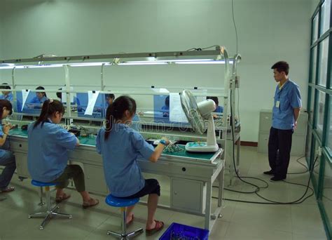 Chinese sweatshop interior. Interior view of a Chinese electronics ...