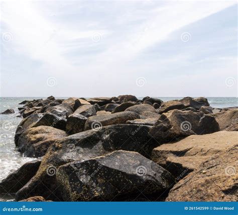 Rock Jetty Sticking Out Into The Ocean With Copy Space Above Stock