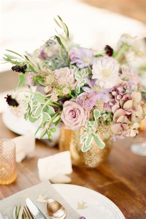 The Table Is Set With Silverware And Flowers