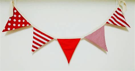 Three Red And White Buntings Hanging On A Wall