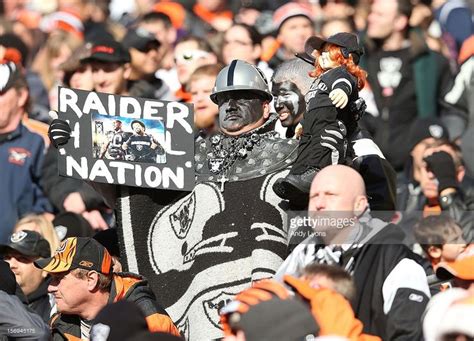 A Oakland Raiders Fan Watches The Action During The Nfl Game Against