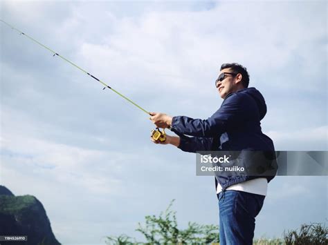 Asian Man Fishing With Nature Background Lifestyle Concept Stock Photo