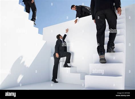 Business stairs helping people hi-res stock photography and images - Alamy