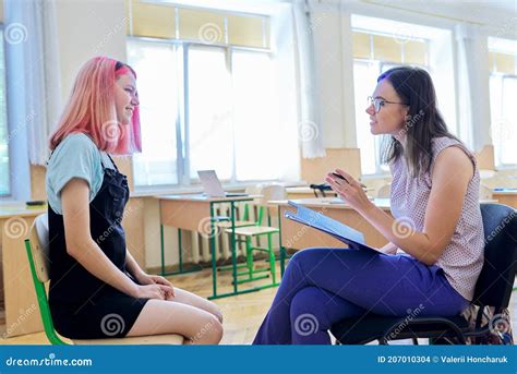 Woman School Psychologist Talking And Helping Student Female Teenager