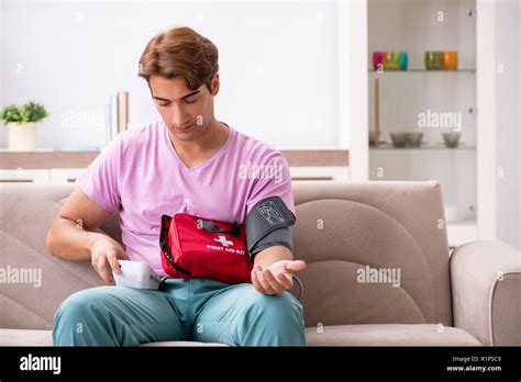 Sick Man At Home With First Aid Kit Stock Photo Alamy