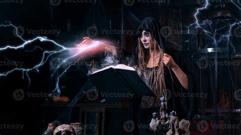 Halloween concept. Witch dressed black hood with dreadlocks standing
