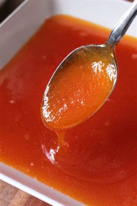 A Spoon Full Of Tomato Sauce In A White Bowl