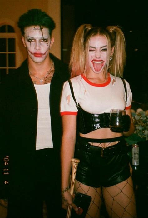 Two People Dressed Up In Costumes And Makeup