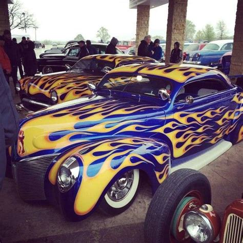 an old car with flames painted on it