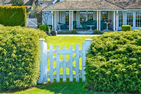 Premium Photo | White wooden entrance gate leading to a front yard patio