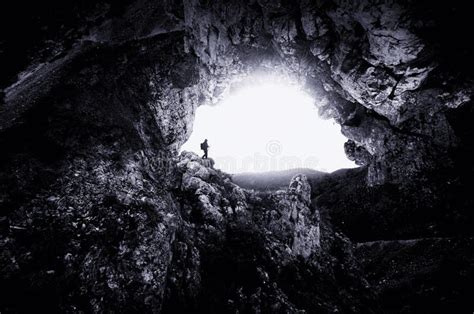 Man At Giant Cave Entrance With Steep Cliffs Stock Photo Image Of