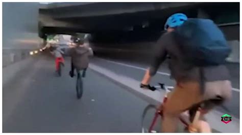 Shocking Moment Cyclist Tries To Shove Rider Pulling A Wheelie Out Of