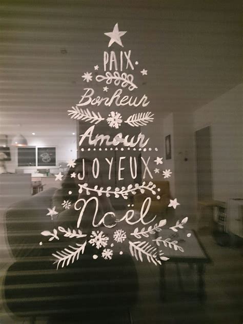 A Christmas Tree Made Out Of White Paper On A Window Sill With The