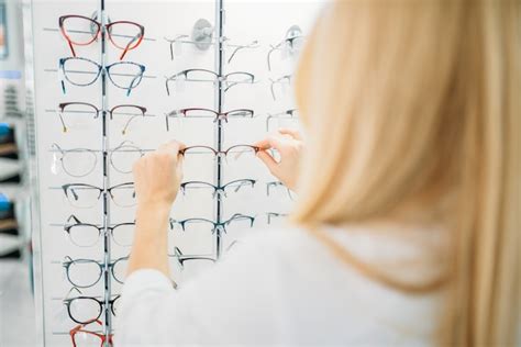 Premium Photo | Female optometrist shows glasses in optics store