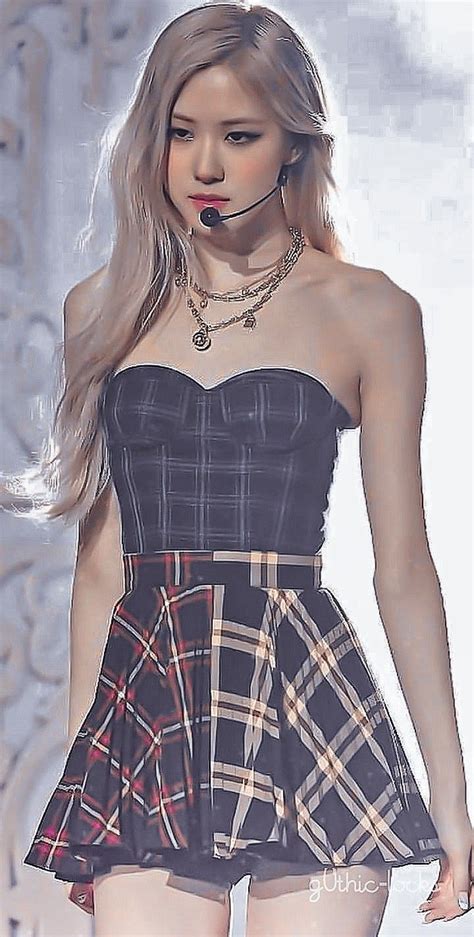 A Woman With Long Hair Wearing A Black And White Plaid Dress Is Walking