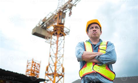 Portrait of crane worker uses walkie-talkie communicate with tower