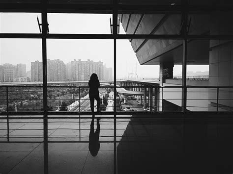 Premium Photo Rear View Of Woman Looking Through Window