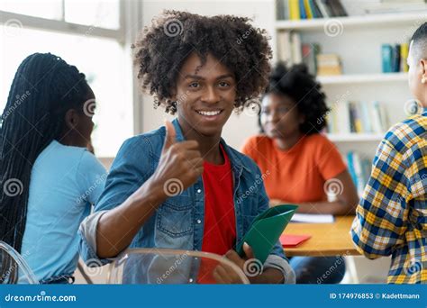 Successful African American Male College Student At Desk At Classroom