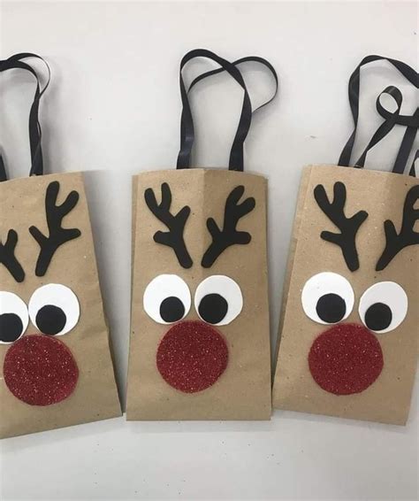 Three Brown Paper Bags With Reindeer Noses On Them