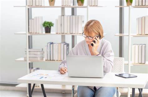 Mature Women Using Laptop Computer Checking Their Bills Woman Reading Documents Mature Woman