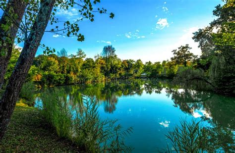 Beautiful Pradella Lake With Green Trees Reflecting On The Water Stock