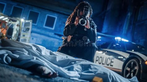 Black Female Police Officer Investigating A Murder Case At A Crime