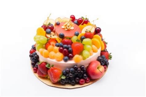 Premium Ai Image A Cake With A Fruit Cake On It And A Bunch Of Fruits