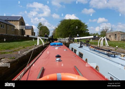 Two Narrowboats In A Lock On The Leeds Liverpool Canal At Gargrave