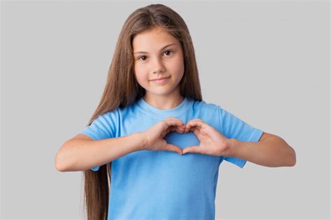 Premium Photo Adorable Small Girl In Blue T Shirt Making A Heart